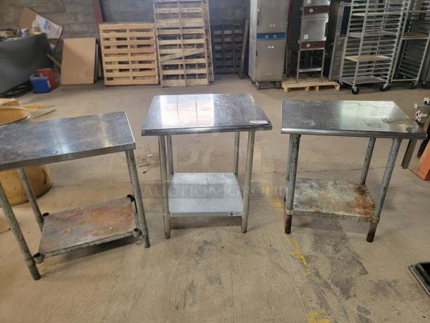 Three stainless steel work tables with shelves, showing signs of wear. Includes Edlund commercial can opener.