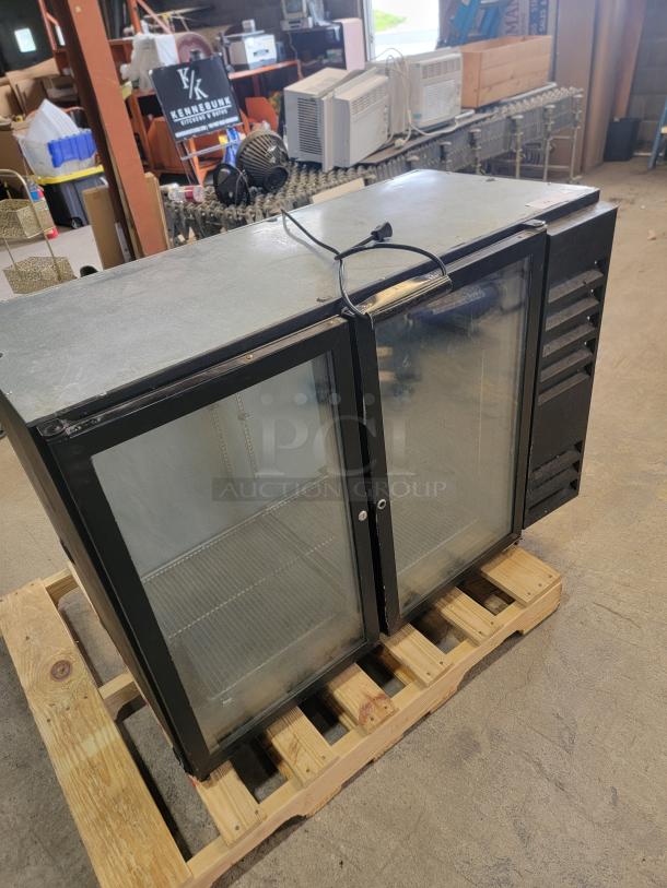 Beverage-Air BB48G commercial back bar cooler with 2 glass doors. Ideal for bars, displays beverages. Good condition, on a pallet.