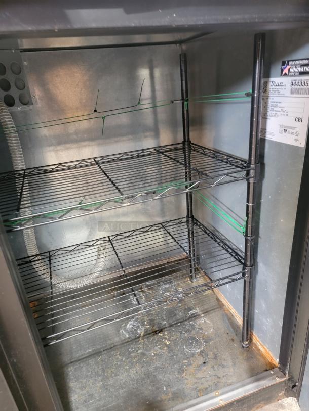 True TDD-4-HC commercial draft beer dispenser interior with wire shelving, visible label, and refrigeration components.