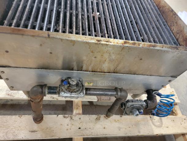 Star-Max 6136RCBF 24" Radiant Gas Charbroiler, used condition, featuring metal grates and visible gas connections.