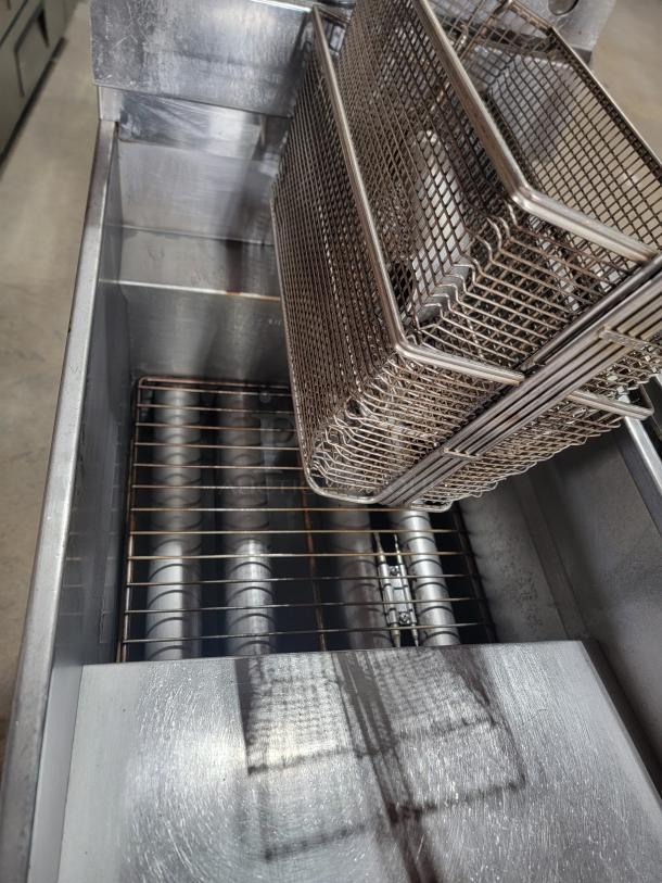 Pitco Frialator SG14 commercial gas deep fryer with baskets. Durable stainless steel, well-maintained, ideal for high-volume use.