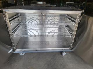 Stainless steel enclosed mobile case cart, Suburban Surgical Company Tote-AL Type C, robust with wire shelves and wheels, ideal for medical or industrial use.