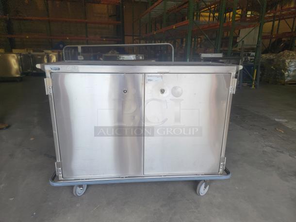 Stainless steel mobile case cart by Suburban Surgical Company, model Tote-AL Type C. Robust, on wheels, ideal for versatile storage.