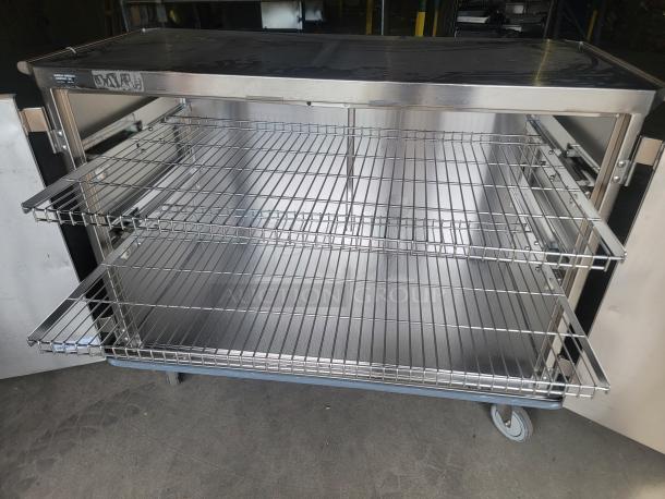 Stainless steel mobile case cart by Suburban, Model Tote-AL Type C, with wire shelves and casters. Suitable for industrial use.