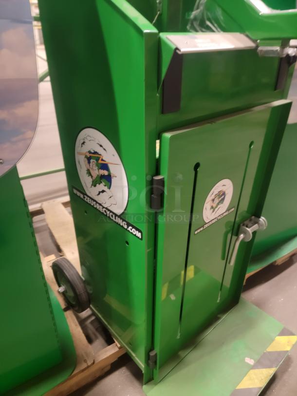 Green Zeus Recycling Compactor & Hand Baler on pallet, featuring company logo. Ideal for waste reduction in industrial settings.
