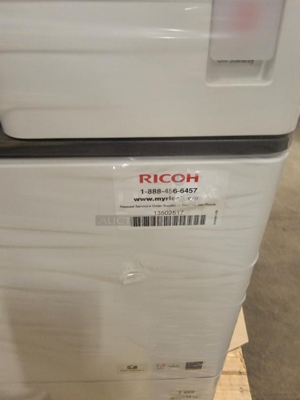 Ricoh MP 3554SP multifunction printer with print, copy, scan, and fax capability. Visible label with service info.