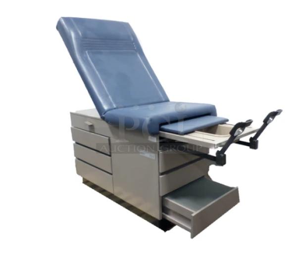 Ritter 104 examination table, blue upholstery, multiple drawers, sturdy design, versatile use; ideal for repurposing.