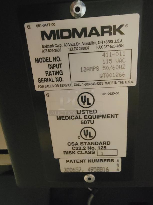 Midmark 75L Medical Examination Chair tag showing model, 115 VAC, 12 AMPS, CSA Standard, Made in USA.