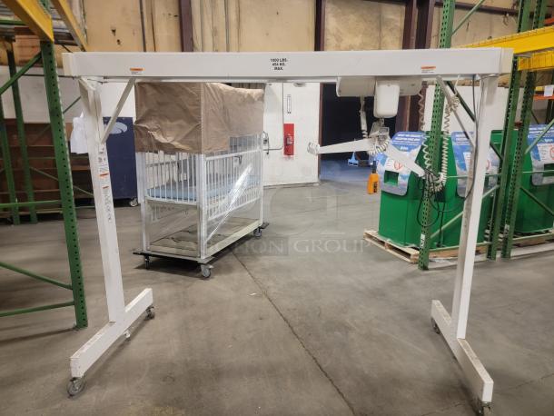 Columbus McKinnon Assist 1000 heavy-duty lift; 1000 lb capacity, mobile, excellent for lifting tasks; white frame, coiled cables.
