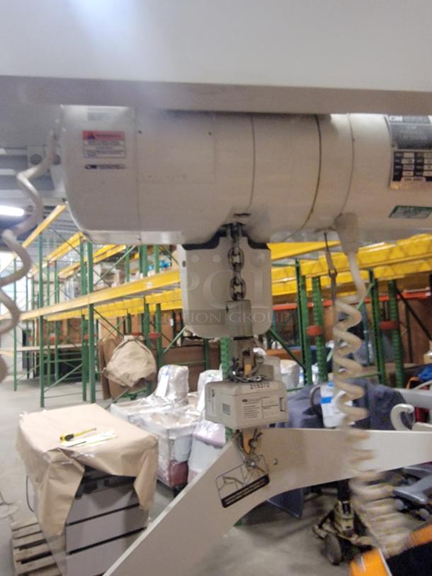 Columbus McKinnon Assist 1000 lift system in workshop; 1000 lb capacity, chain hoist, professional-grade condition.