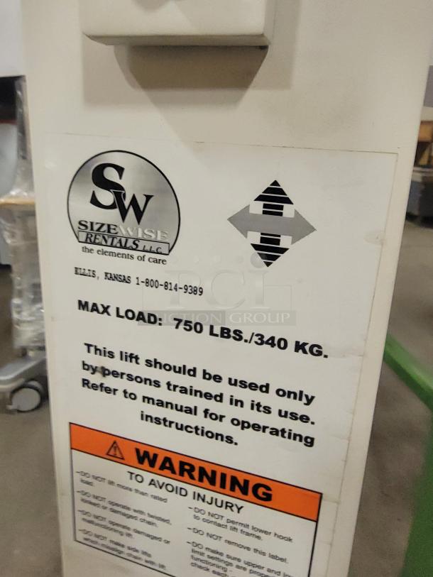 CM Assist 1000 heavy-duty lifting system, visible label showing 750 lb max load, warning, and use instructions.
