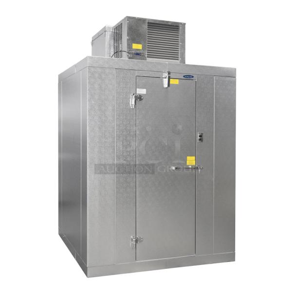 Commercial walk-in freezer, metal finish, with cooling unit on top. Features locking handle and visible safety signage.