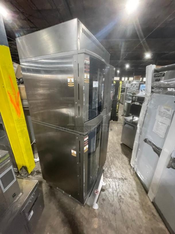 Industrial stainless steel double-door refrigeration unit, stackable design, very good condition, caution labels visible.