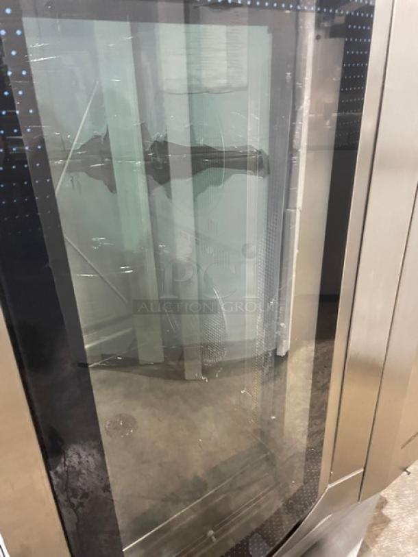 Commercial convection oven with glass door, stainless steel exterior, double-hinged handle, in good condition.