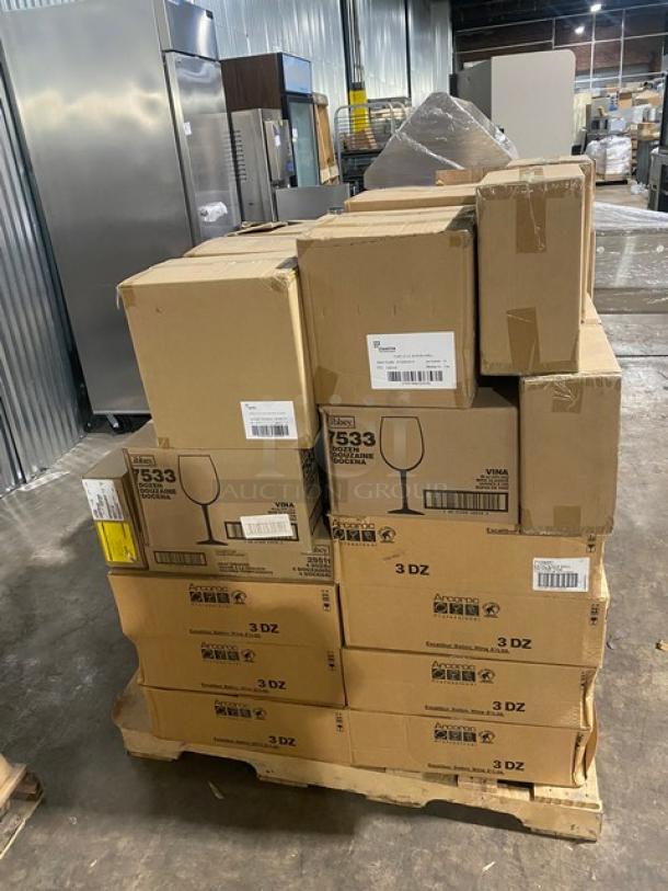 Pallet of stacked cardboard boxes containing glassware, labeled "3 DZ" with wine glass symbols, in warehouse setting.