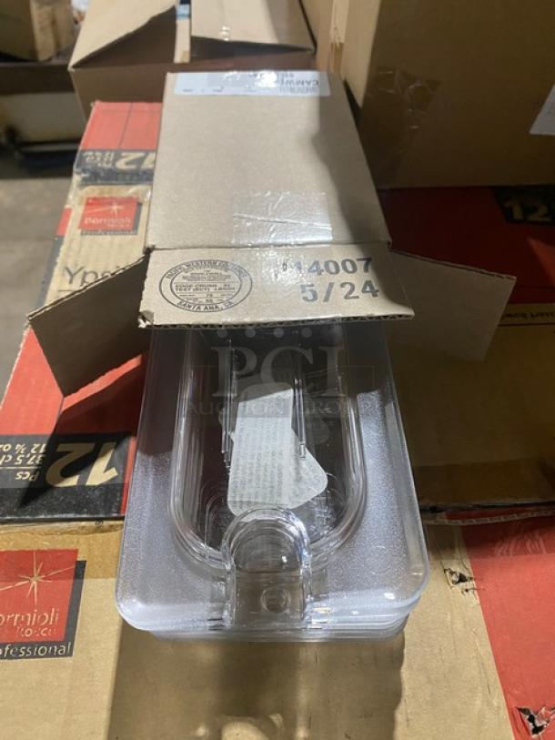Clear plastic food storage container in box, marked with "14007 5/24," partially opened on a cardboard box.