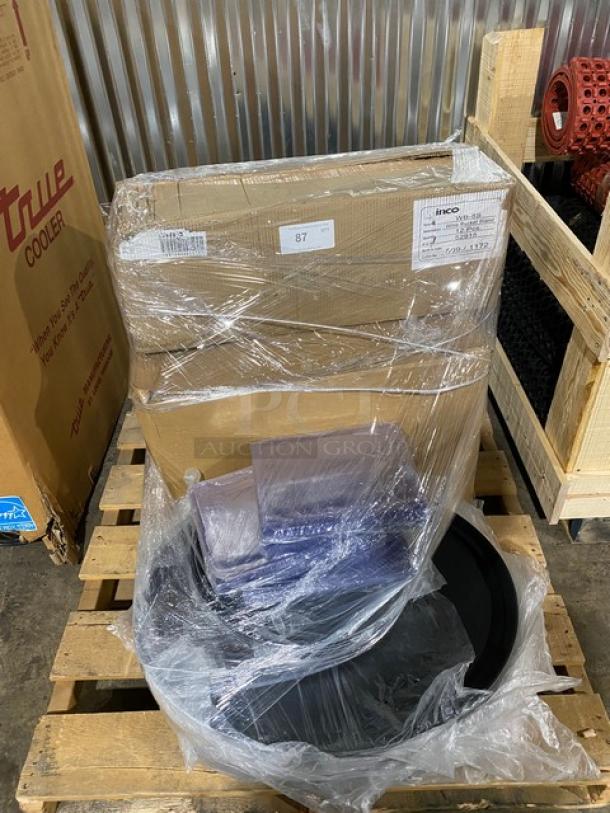 Pallet with wrapped boxes and parts, labeled INCO. Items appear new in packaging, potential industrial or mechanical use.