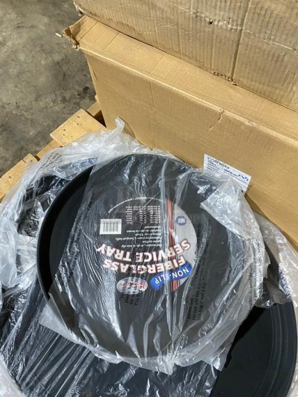 Round black fiberglass service trays in packaging. Labeled "Non-Slip" and "NSF." New condition with cardboard box.