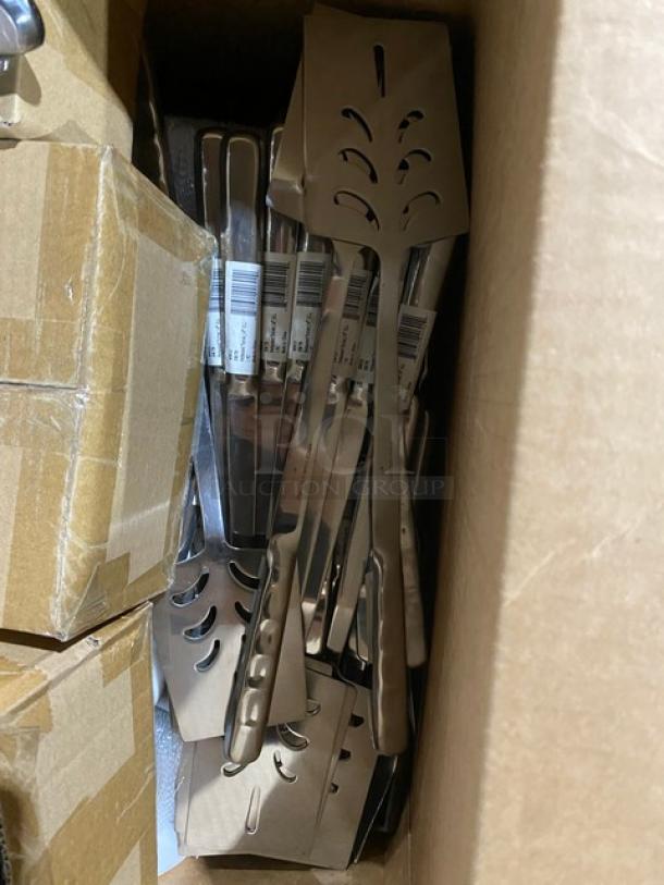 Box of stainless steel slotted spatulas, new condition, with barcode labels visible. Ideal for kitchen use or resale.