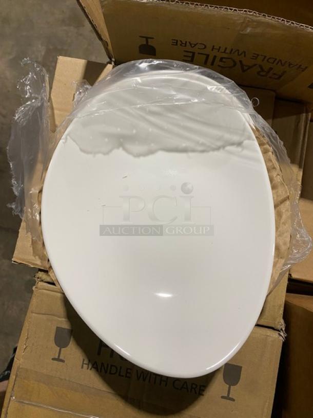 Round white porcelain toilet seat, new in plastic wrap, placed on cardboard boxes labeled "Fragile."