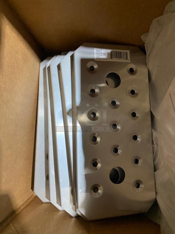 Stack of metal plates in a box, featuring multiple holes. Visible barcode and numerical label indicating model details.