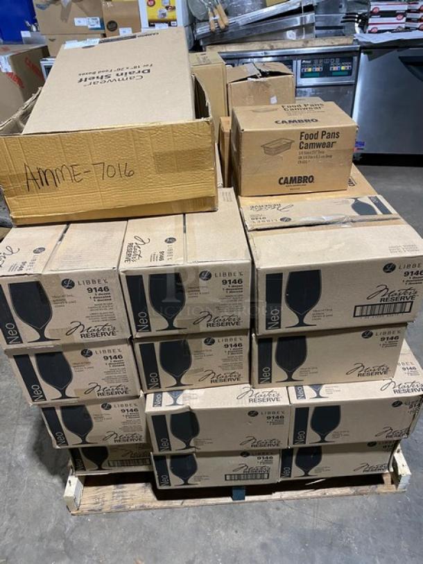 Boxes of Libbey Master's Reserve glassware and Cambro food pans stacked on a pallet, new condition, sealed packaging.