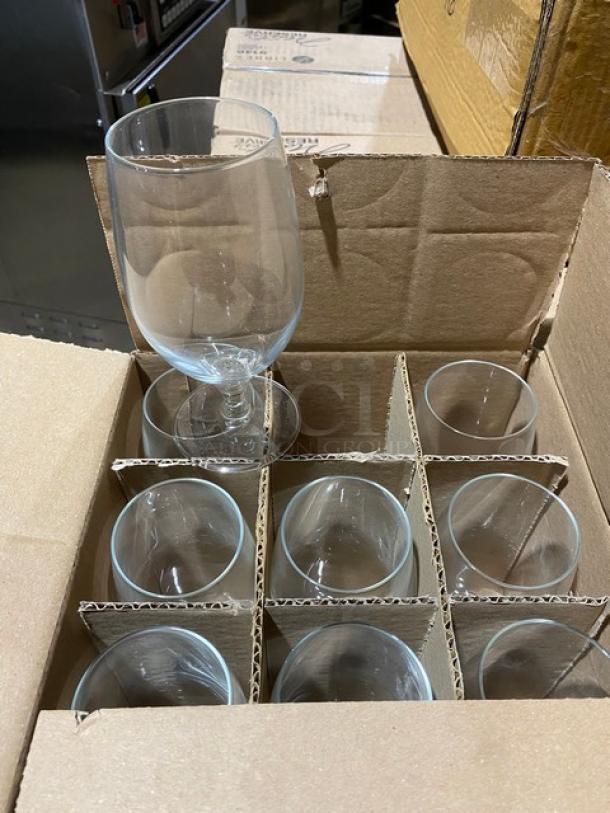 Set of 10 clear glass goblets in original cardboard box, unused, with partitioned sections for protection.