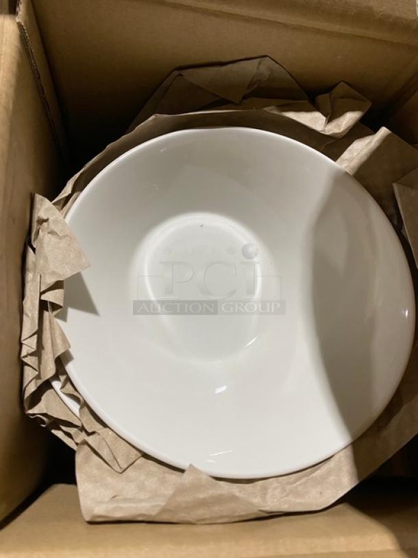 White ceramic bowl in excellent condition, nestled in a cardboard box with brown packing paper.