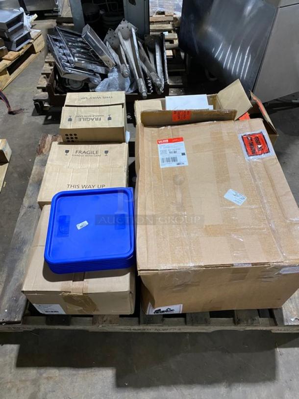 Assorted sealed boxes on a pallet, some marked "Fragile" and "This Way Up," one with a blue lid.