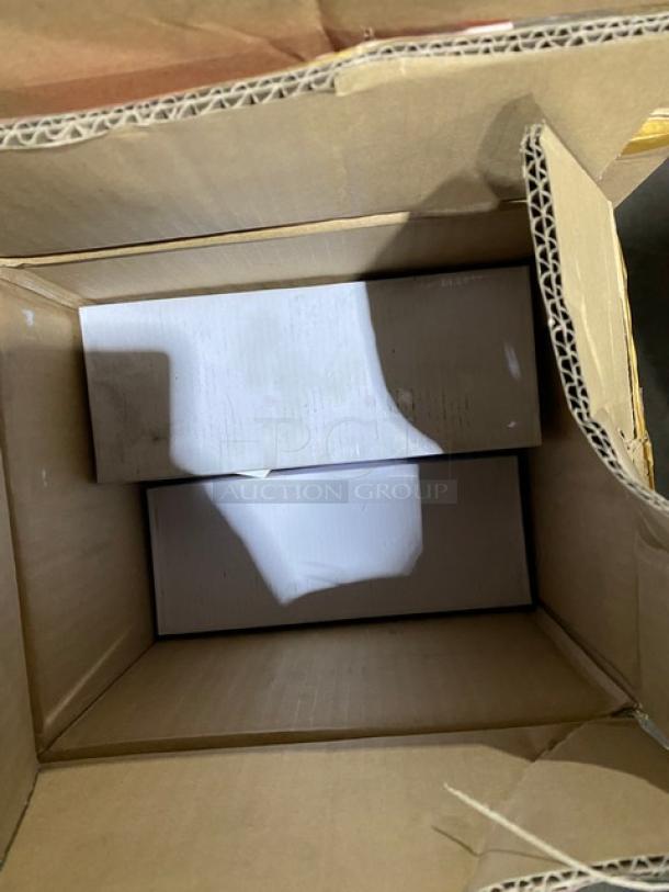 Open cardboard box with two white, rectangular boxes inside. Box appears unused and in good condition.