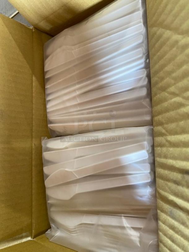 Box of individually wrapped plastic cutlery sets in new condition, neatly packed in cardboard box.
