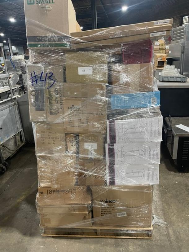 Mixed pallet of brand new commercial kitchen items wrapped in plastic, including Edlund can opener U-12, Lorell cork board 19763, Taylor scale TE10FT, and more, on a wooden pallet.