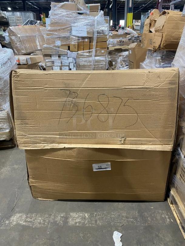 Cardboard box containing a brand new John Boos stainless steel worktop table set, models ST6R53048SBK, OSE26FK1248, and PBDISINK090905SSLR. Boxes in warehouse background.