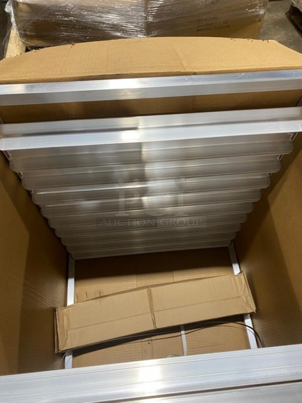 Brand new New Age Industries Model 1312 aluminum sheet pan rack, open top, half-size, end load, with casters, in box.