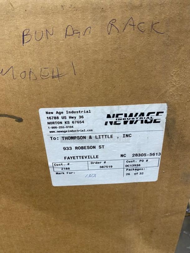 Brand new New Age Industries aluminum bun/sheet pan rack with casters. Model 1312. Shipping label to Fayetteville, NC.