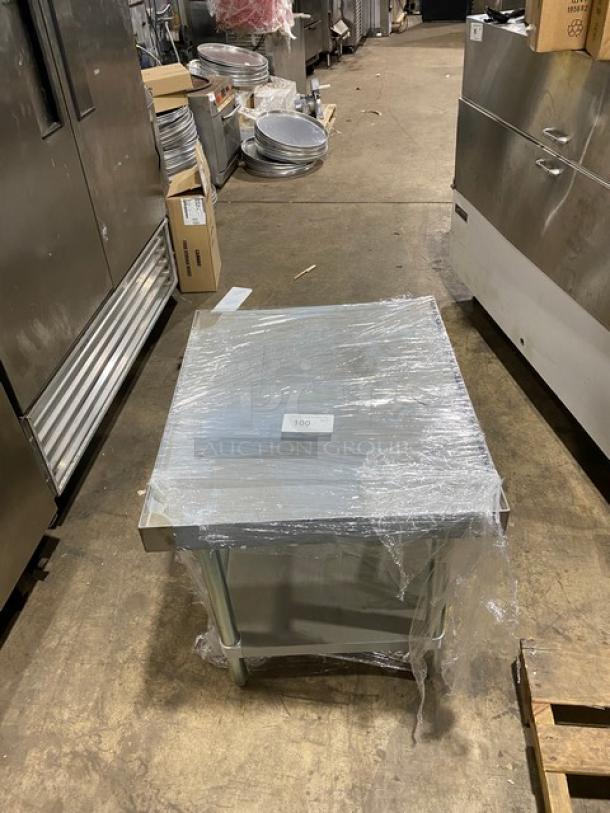 Brand new Adcraft ES3024 stainless steel equipment stand with undershelf, back & side splash. On legs, wrapped in packaging.
