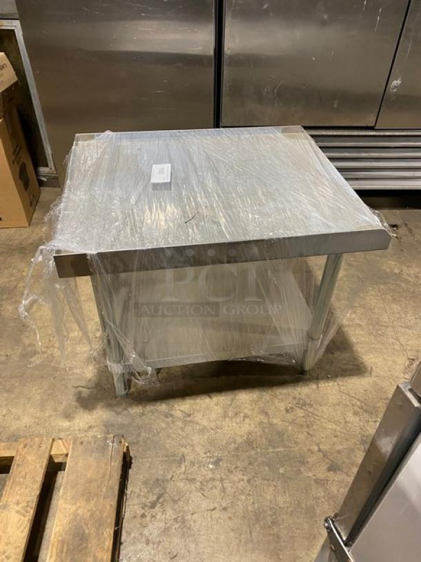 Brand new Adcraft ES3024 stainless steel equipment stand with undershelf, back, and side splash, still in wrap.