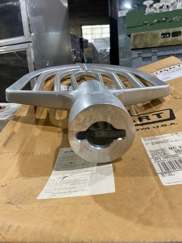 Brand new Hobart Legacy BEATER-HL140 aluminum flat beater attachment, with packaging visible, in pristine condition.