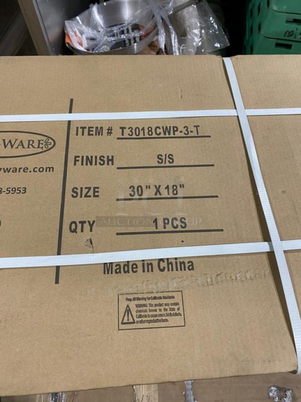 Serv-Ware commercial stainless steel table, model T3018CWP3T, 18"x30", with 2" backsplash, on legs, in original packaging.