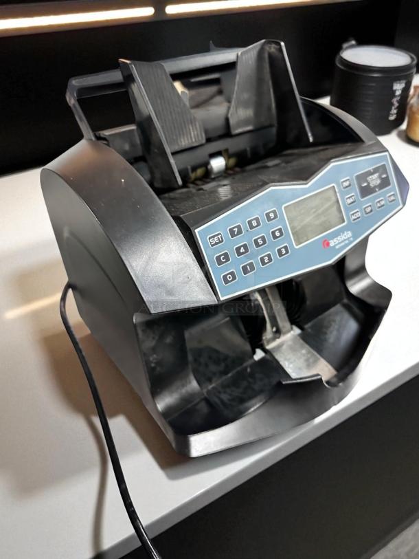 Cassida Advantec 75 bill counter in excellent condition, 120V, fully tested and working, with digital interface and power cord.