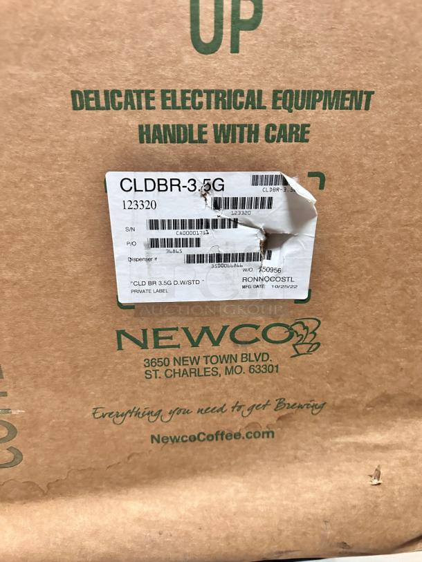 Brand new Newco 123320 Cold Brew Brewer CLDBR-3.5G, 3.5 gallons, packaged in box. "Handle with care" label visible.