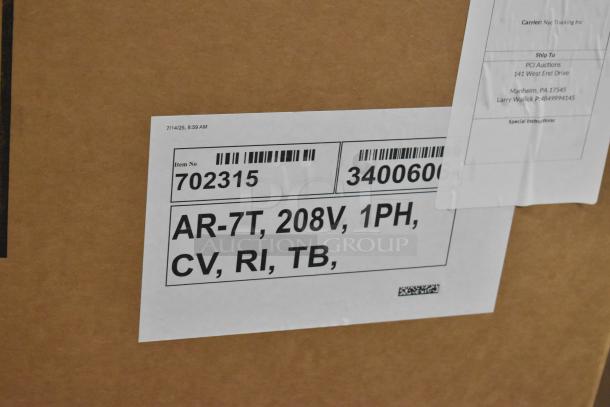 Brand new Alto Shaam AR-7T rotisserie oven, 208V, 1PH, stainless steel, in original box. Model info and shipping labels visible.