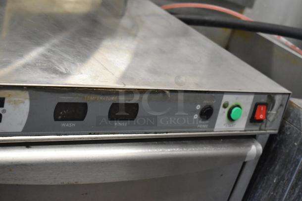 Champion UIH30B stainless steel commercial undercounter dishwasher with controls for wash, rinse, and temperature display.