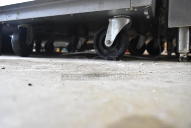 Beverage Air ER24-1AS commercial cooler bottom view, showing commercial casters. Stainless steel construction. 115 volts.