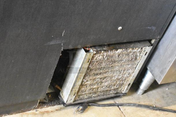 Continental CBC50 stainless steel commercial back bar bottle cooler, 115V, with visible condenser coils, in used condition.