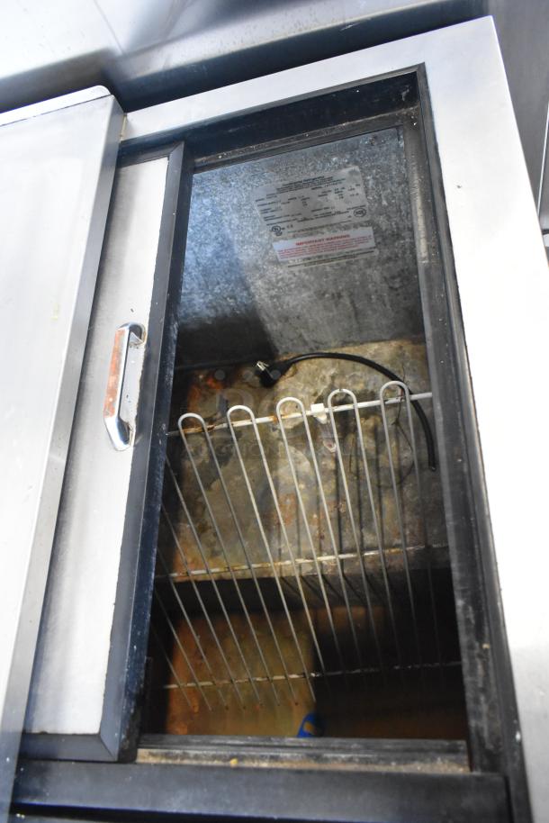 Continental CBC50 stainless steel back bar cooler, open lid view, shows interior wire shelf, label, and cord, 115V, 1 phase.