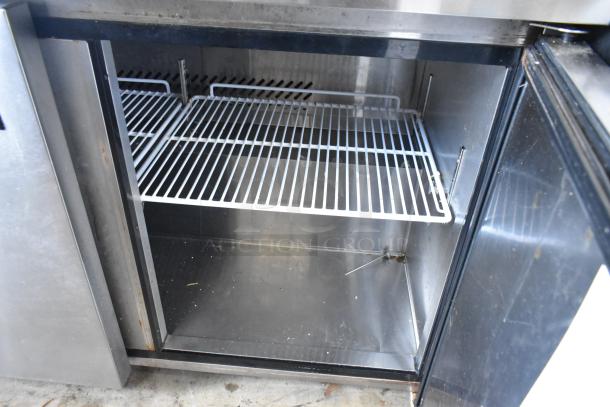 2019 Bison BUR-48 stainless steel two-door undercounter cooler. Features metal shelving, 115V, 1 phase. Good condition.