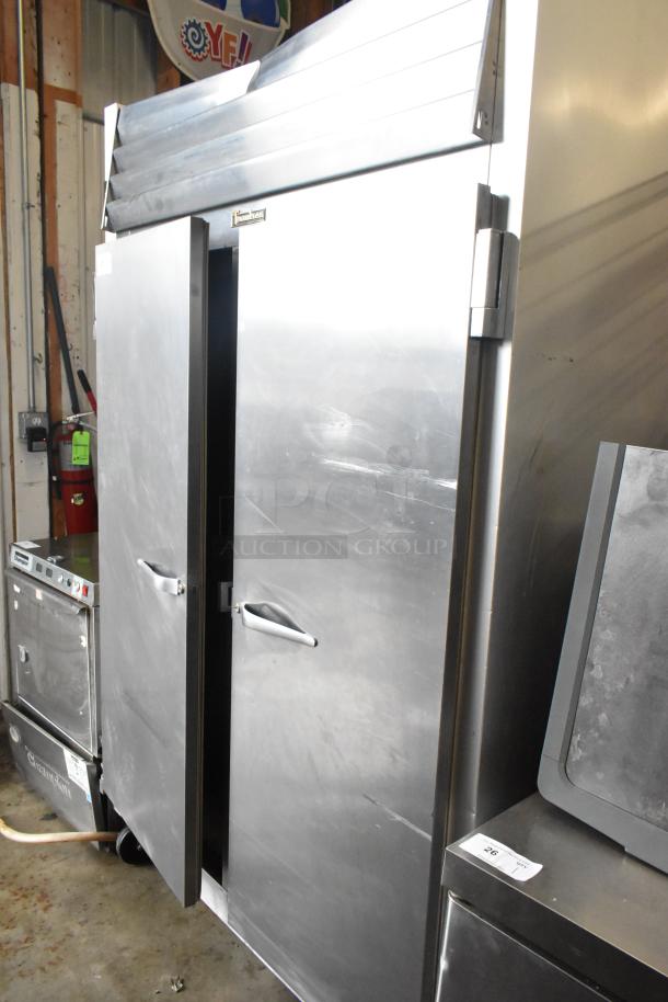 Traulsen G20010 stainless steel commercial 2-door reach-in cooler with poly-coated racks and commercial casters.