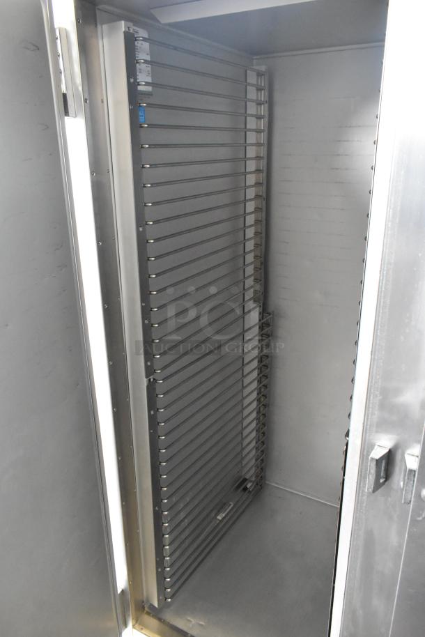 Traulsen G20010 stainless steel commercial 2-door reach-in cooler with poly-coated racks and commercial casters. 115 volts.