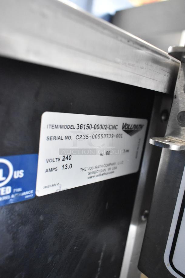 Vollrath 36150-00002-CNC stainless steel commercial buffet station, 240V, 1 phase, on casters, label shows model and voltage info.